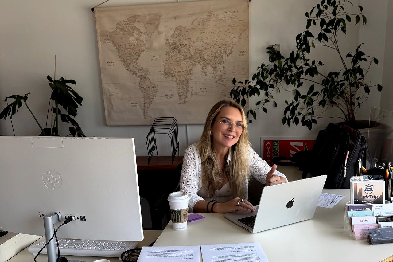 Rosane Damazio at her New York office, at her desk in front of a world map, working on an international matter.