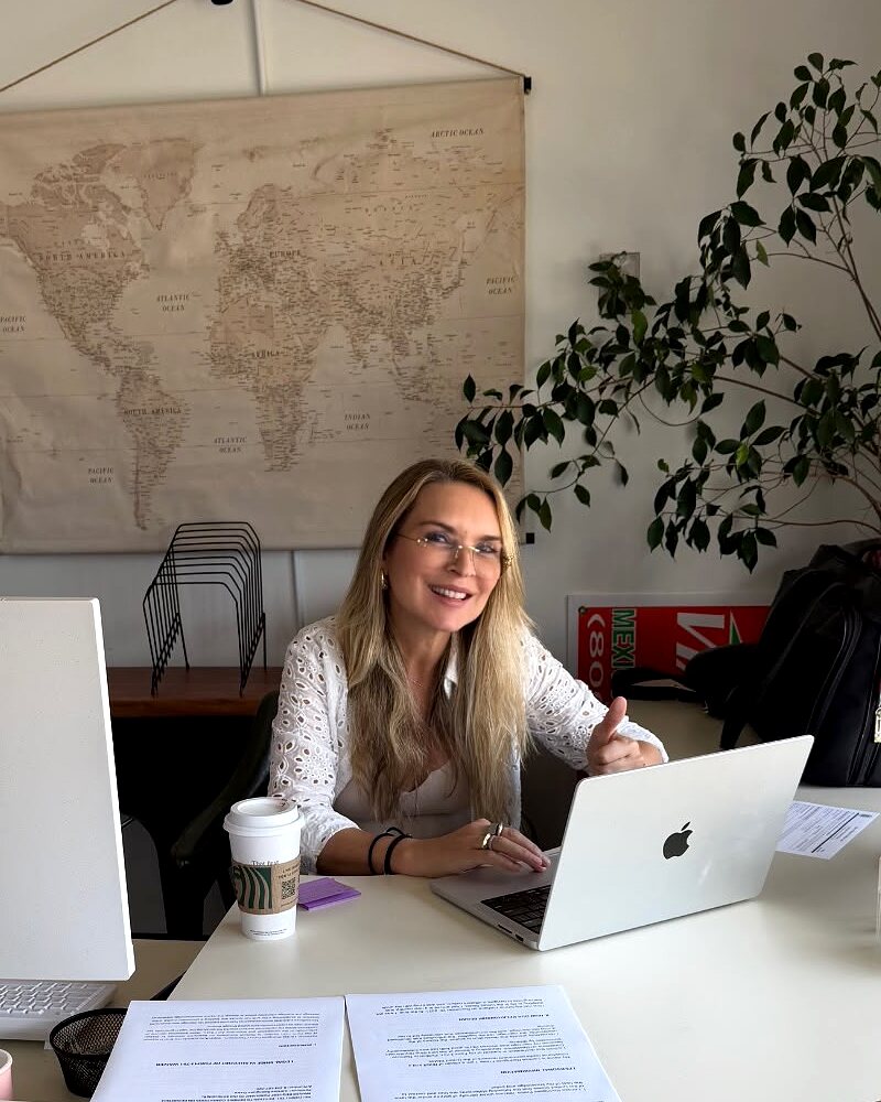 Rosane Damazio at her New York office, at her desk in front of a world map, working on an international matter.